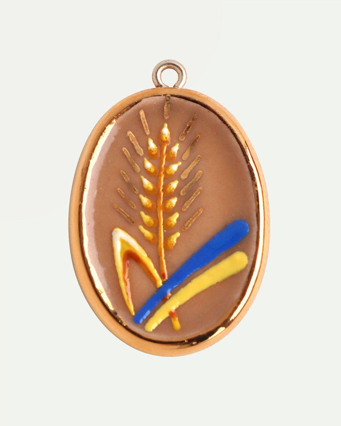 Колосок з прапором на пісочному тлі 